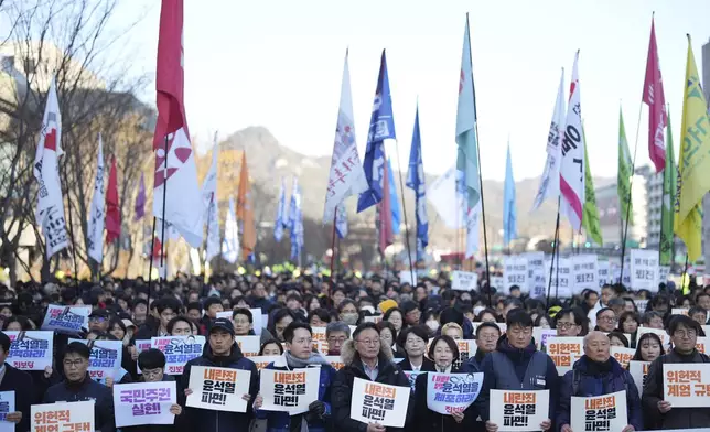 South Koreans hold signs reading "Expulsion of Yoon Suk Yeol" during a rally in Seoul, South Korea, Wednesday, Dec. 4, 2024. (AP Photo/Lee Jin-man)