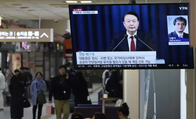 A TV screen shows South Korean President Yoon Suk Yeol's televised briefing at a bus terminal in Seoul, South Korea, Tuesday, Dec. 3, 2024. (AP Photo/Ahn Young-joon)