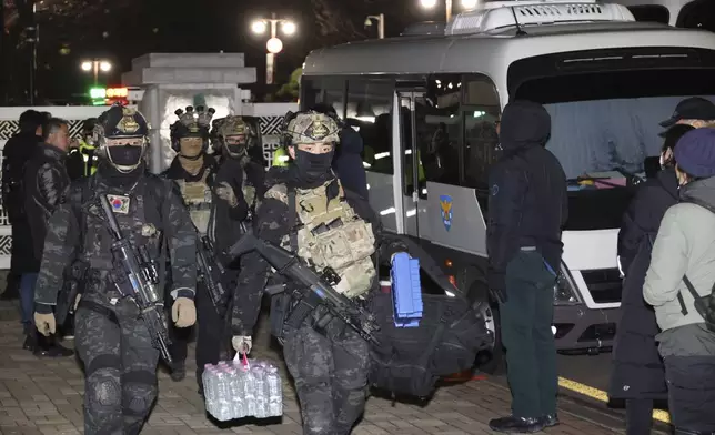 South Korean martial law soldiers leave the National Assembly in Seoul, South Korea, Wednesday, Dec. 4, 2024. (Kim Ju-sung/Yonhap via AP)