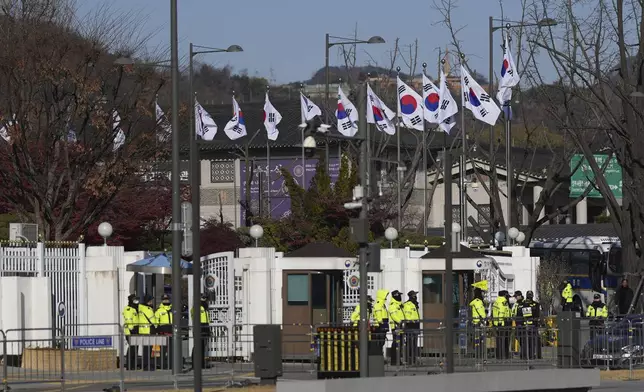 South Korean police officers stand guard in front of the government complex in Seoul, South Korea, Wednesday, Dec. 4, 2024. (AP Photo/Lee Jin-man)