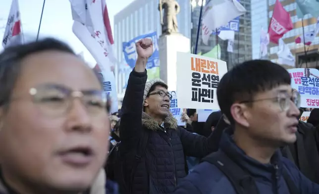 South Koreans shout slogans during a rally in Seoul, South Korea, Wednesday, Dec. 4, 2024. (AP Photo/Lee Jin-man)