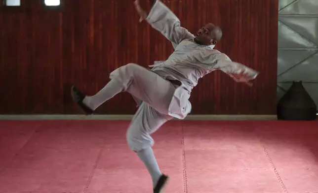 Evans Munzaa, 30 years, demonstrates a stance of kung fu, a Chinese martial art, at a training school in Kabiria on the outskirts of Nairobi, Kenya Tuesday, Nov. 12, 2024. (AP Photo/Henry Naminde)