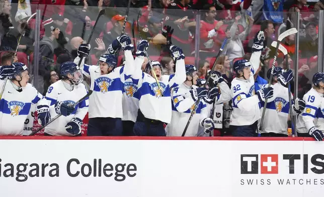 The players on the Finland bench celebrate after a goal by teammate Arttu Alasiurua against the United States during first-period IIHF World Junior Hockey Championship tournament game action in Ottawa, Ontario, Sunday, Dec. 29, 2024. (Sean Kilpatrick/The Canadian Press via AP)