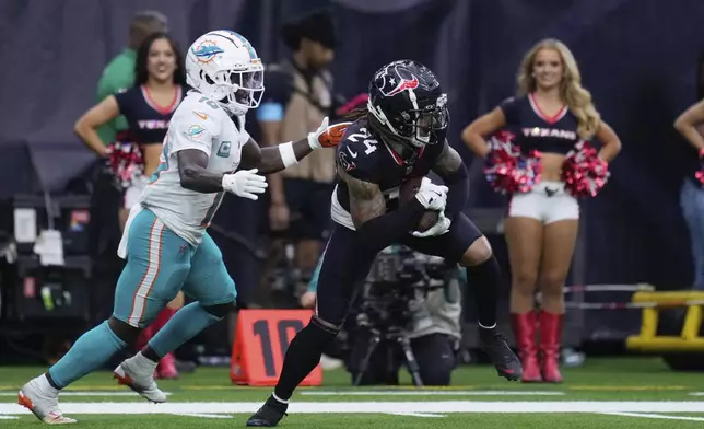 Houston Texans cornerback Derek Stingley Jr. (24) intercepts a pass intended for Miami Dolphins wide receiver Tyreek Hill (10) during the second half of an NFL football game Sunday, Dec. 15, 2024, in Houston. (AP Photo/Eric Christian Smith)