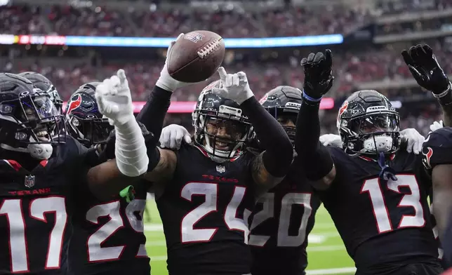 Houston Texans cornerback Derek Stingley Jr. (24) and teammates celebrate his interception during the second half of an NFL football game against the Miami Dolphins, Sunday, Dec. 15, 2024, in Houston. (AP Photo/Ashley Landis)