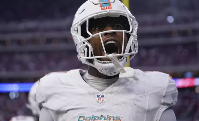 Miami Dolphins tight end Jonnu Smith (9) celebrates scoring a touchdown during the second half of an NFL football game against the Houston Texans, Sunday, Dec. 15, 2024, in Houston. (AP Photo/Eric Christian Smith)