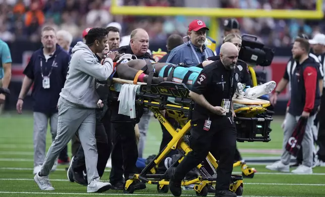 Miami Dolphins wide receiver Grant DuBose (88) is carted off the field after being injured during the second half of an NFL football game against the Houston Texans, Sunday, Dec. 15, 2024, in Houston. (AP Photo/Eric Christian Smith)