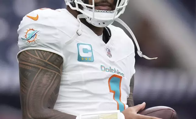 Miami Dolphins quarterback Tua Tagovailoa (1) walks on the field during warmups ahead of an NFL football game against the Houston Texans, Sunday, Dec. 15, 2024, in Houston. (AP Photo/Eric Christian Smith)