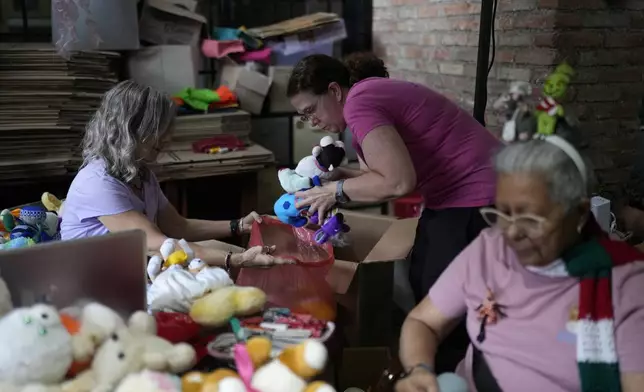 Volunteers recycle and restore used toys to donate them to vulnerable children as Christmas presents at the non-profit foundation Hospital de los Peluches, or Hospital of Stuffed Animals, in Caracas, Venezuela, Thursday, Dec. 5, 2024. (AP Photo/Ariana Cubillos)