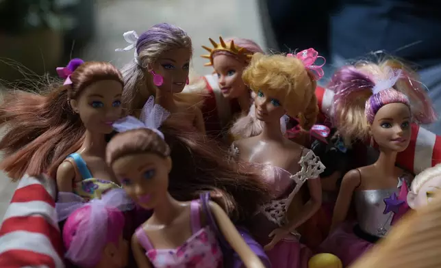 Restored Barbie dolls are collected in a basket at the non-profit foundation Hospital de los Peluches, or Hospital of Stuffed Animals, where recycled toys are restored to be donated to vulnerable children as Christmas presents, in Caracas, Venezuela, Thursday, Dec. 5, 2024. (AP Photo/Ariana Cubillos)