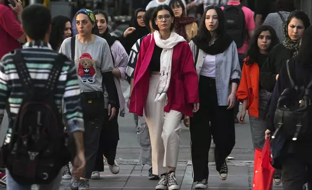 FILE Iranian women, some without wearing their mandatory Islamic headscarves, walk in downtown Tehran, Iran, Saturday, Sept. 9, 2023. (AP Photo/Vahid Salemi, File)