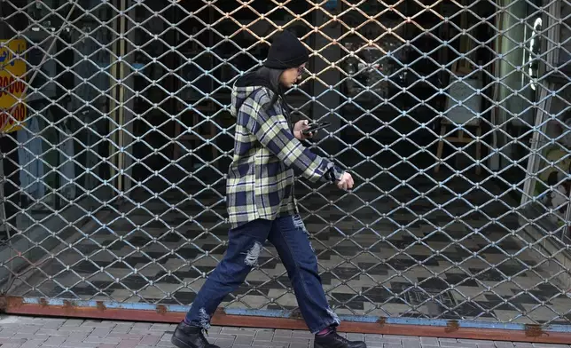 An Iranian woman walks in port city of Bandar Anzali in northern Iran, Thursday, Dec. 5, 2024. (AP Photo/Vahid Salemi)