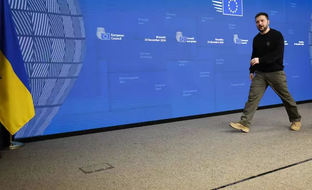 Ukraine's President Volodymyr Zelenskyy leaves the podium after addressing a media conference during an EU summit in Brussels, Thursday, Dec. 19, 2024. (AP Photo/Geert Vanden Wijngaert)