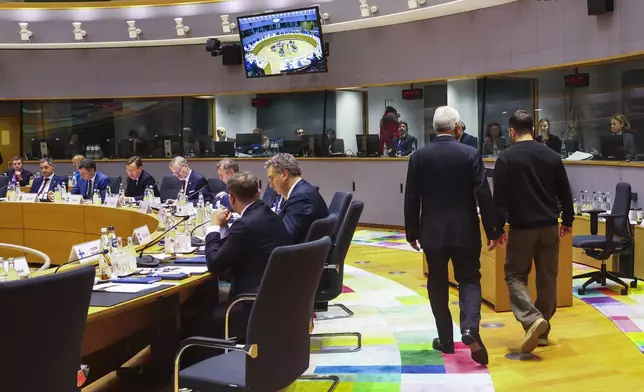 Ukraine's President Volodymyr Zelenskyy, right, and European Council President Antonio Costa arrives for a round table meeting during an EU summit in Brussels on Thursday, Dec. 19, 2024. (Johanna Geron, Pool Photo via AP)