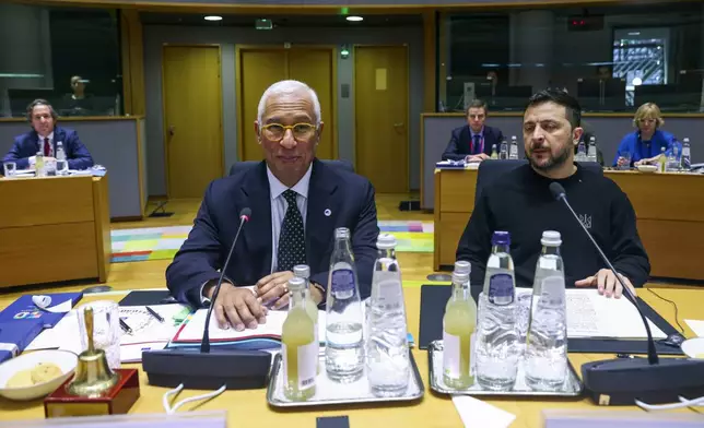 Ukraine's President Volodymyr Zelenskyy, right, and European Council President Antonio Costa attend a round table meeting during an EU summit in Brussels on Thursday, Dec. 19, 2024. (Johanna Geron, Pool Photo via AP)