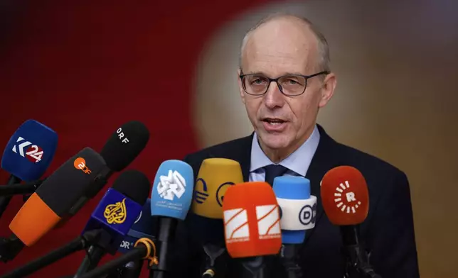 Luxembourg's Prime Minister Luc Frieden speaks with the media as he arrives for an EU summit at the European Council building in Brussels, Thursday, Dec. 19, 2024. (AP Photo/Geert Vanden Wijngaert)