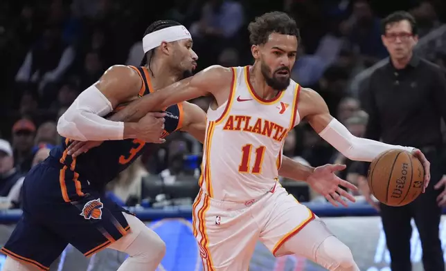 Atlanta Hawks' Trae Young (11) drives past New York Knicks' Josh Hart (3) during the first half of an Emirates NBA Cup basketball game Wednesday, Dec. 11, 2024, in New York. (AP Photo/Frank Franklin II)