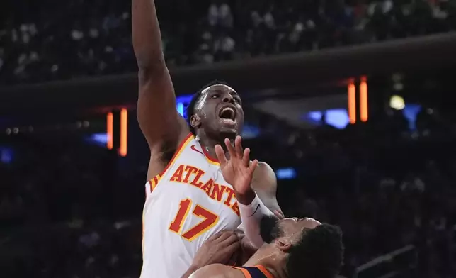 Atlanta Hawks' Onyeka Okongwu (17) shoots over New York Knicks' Karl-Anthony Towns (32) during the first half of an Emirates NBA Cup basketball game Wednesday, Dec. 11, 2024, in New York. (AP Photo/Frank Franklin II)