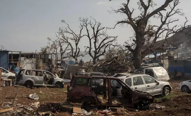 Broken cars are seen in Barakani, Mayotte, France on Saturday, Dec. 21, 2024. (AP Photo/Adrienne Surprenant)