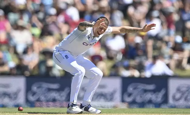 England's Brydon Carse celebrates after taking the wicket of New Zealand's Nathan Smith during play on the fourth day of the first cricket test between England and New Zealand at Hagley Oval in Christchurch, New Zealand, Sunday, Dec. 1, 2024.(John Davidson/Photosport via AP)