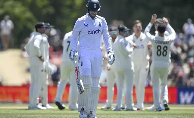 England's Zak Crawley walks from the field after he was dismissed during play on the fourth day of the first cricket test between England and New Zealand at Hagley Oval in Christchurch, New Zealand, Sunday, Dec. 1, 2024.(John Davidson/Photosport via AP)