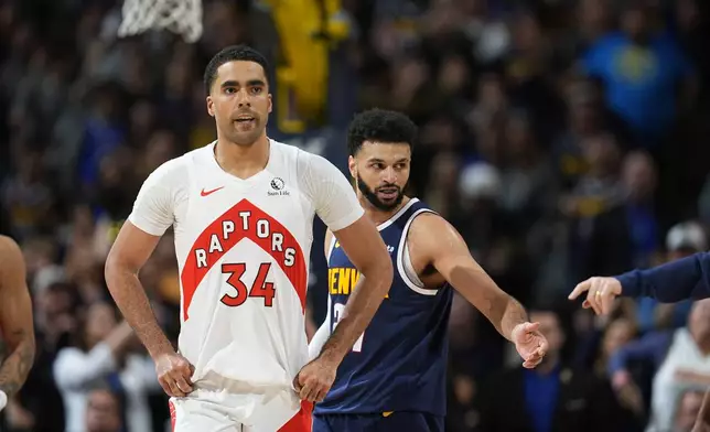 FILE - Toronto Raptors center Jontay Porter (34) and Denver Nuggets guard Jamal Murray (27) look on in the second half of an NBA basketball game Monday, March 11, 2024, in Denver. (AP Photo/David Zalubowski, File)