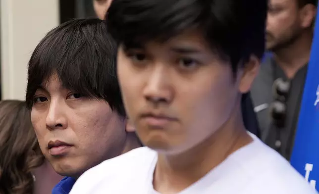 FILE - Interpreter Ippei Mizuhara, left, stands next to Los Angeles Dodgers baseball player Shohei Ohtani, right, during an interview at Dodger Stadium, Feb. 3, 2024. (AP Photo/Richard Vogel, File)