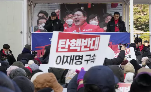 Supporters of impeached South Korean President Yoon Suk Yeol stage a rally against his impeachment near the Seoul Central District Court in Seoul, South Korea, Tuesday, Dec. 17, 2024. The signs read "Oppose the impeachment and Arrest opposition Democratic Party leader Lee Jae-myung." (AP Photo/Ahn Young-joon)