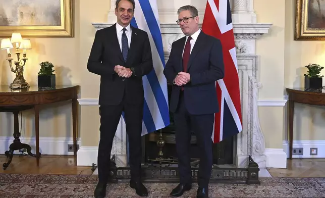 Britain's Prime Minister Keir Starmer, right, and Greece's Prime Minister Kyriakos Mitsotakis, left, pose for a photograph ahead of their meeting inside of 10 Downing Street in London, England, Tuesday, Dec. 3, 2024. (Justin Tallis/Pool Photo via AP)