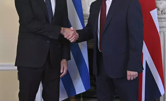 Britain's Prime Minister Keir Starmer, right, and Greece's Prime Minister Kyriakos Mitsotakis, left, pose for a photograph ahead of their meeting inside of 10 Downing Street in London, England, Tuesday, Dec. 3, 2024. (Justin Tallis/Pool Photo via AP)