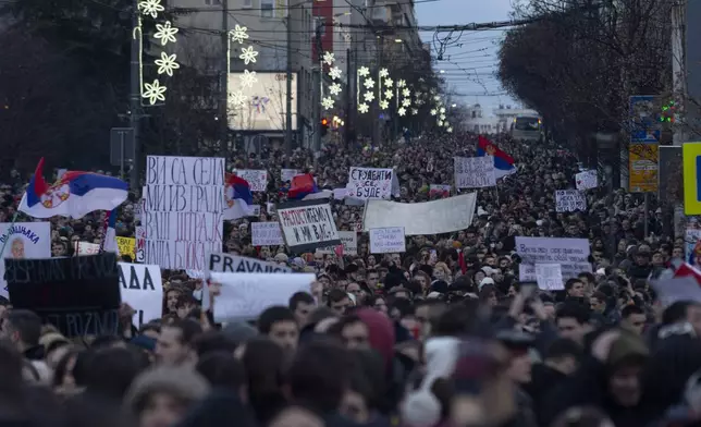 Protesters crowd a street during a protest against populist President Aleksandar Vucic and his government, whose tight grip on power has been challenged by weeks of street protests led by university students, in central Belgrade, Serbia, Sunday, Dec. 22, 2024. (AP Photo/Marko Drobnjakovic)