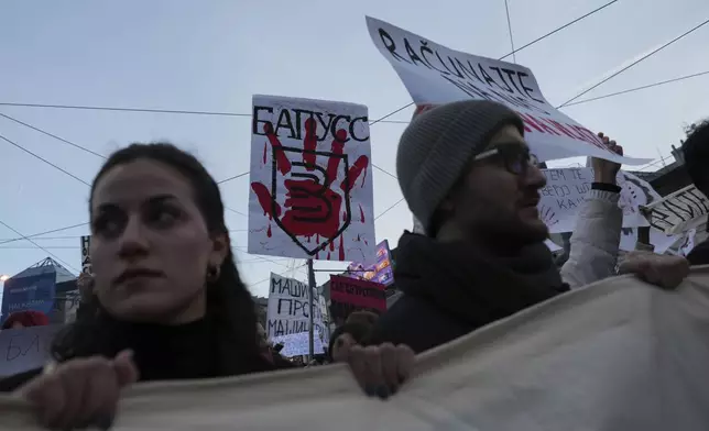 People attend a protest against the Serbian authorities in Belgrade, Serbia, Sunday, Dec. 22, 2024. (AP Photo/Darko Vojinovic)