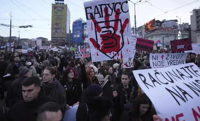 People attend a protest against the Serbian authorities in Belgrade, Serbia, Sunday, Dec. 22, 2024. (AP Photo/Darko Vojinovic)