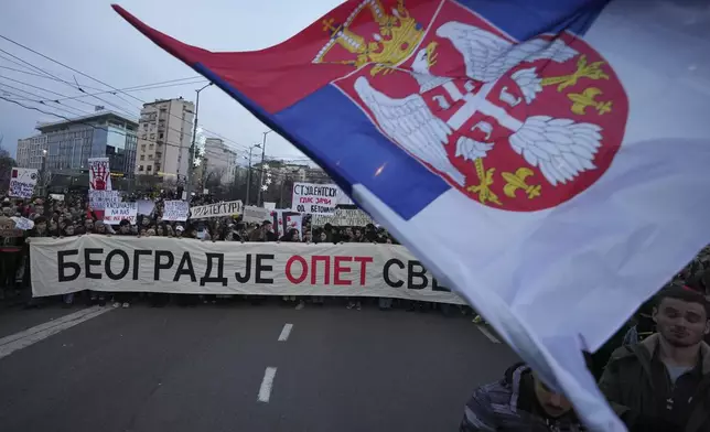 People attend a protest against the Serbian authorities in Belgrade, Serbia, Sunday, Dec. 22, 2024. (AP Photo/Darko Vojinovic)