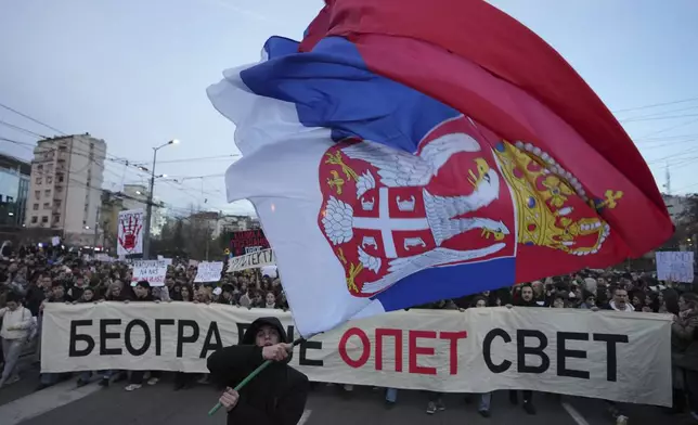 People attend a protest against the Serbian authorities in Belgrade, Serbia, Sunday, Dec. 22, 2024. (AP Photo/Darko Vojinovic)