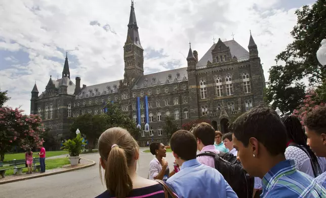 FILE - Prospective students tour Georgetown University's campus in Washington, July 10, 2013. (AP Photo/Jacquelyn Martin, File)