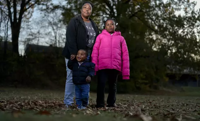 Anika Chillis stands for a photo with her children Makhi 2, and Myla 9, Monday, Dec. 2, 2024, in Memphis, Tenn. (AP Photo/George Walker IV)