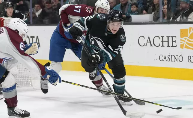 San Jose Sharks left wing William Eklund, middle, skates toward the puck against Colorado Avalanche left wing Artturi Lehkonen, left, and defenseman Keaton Middleton (67) during the first period of an NHL hockey game in San Jose, Calif., Thursday, Dec. 19, 2024. (AP Photo/Jeff Chiu)