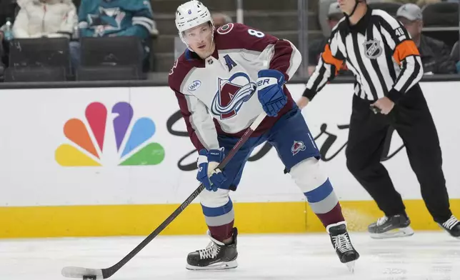 Colorado Avalanche defenseman Cale Makar (8) passes the puck against the San Jose Sharks during the first period of an NHL hockey game in San Jose, Calif., Thursday, Dec. 19, 2024. (AP Photo/Jeff Chiu)