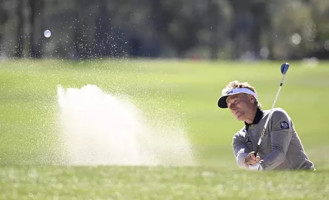 Bernhard Langer hits out of a bunker onto the third green during the final round of the PNC Championship golf tournament, Sunday, Dec. 22, 2024, in Orlando, Fla. (AP Photo/Phelan M. Ebenhack)