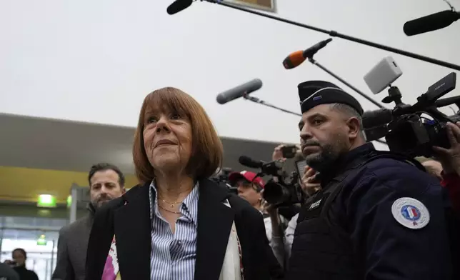 Gisele Pelicot, who was allegedly drugged by her now former husband so that he and others could assault her, arrives at the court house in Avignon, southern France, Thursday, Dec. 19, 2024. (AP Photo/Lewis Joly)