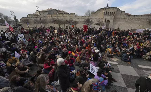 FILE - Activists gather during a women's rights demonstration, Dec. 14, 2024, in Avignon, southern France, where the trial of dozens of men accused of raping Gisèle Pelicot while she was drugged and rendered unconscious by her husband is taking place. (AP Photo/Aurelien Morissard, File)