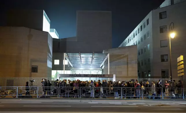 Media wait outside the courthouse of Avignon during the trial of four dozen men charged with aggravated rape and sexual assault on Gisèle Pelicot, in Avignon, southern France, Thursday, Dec. 19, 2024. (AP Photo/Lewis Joly)