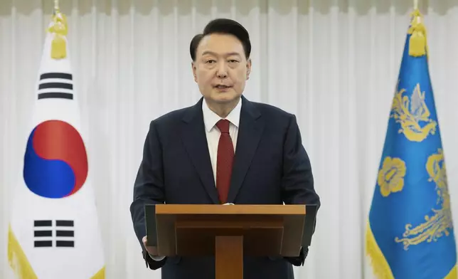 In this photo released by South Korean President Office via Yonhap, South Korean President Yoon Suk Yeol speaks at the presidential residence in Seoul, South Korea, Saturday, Dec. 14, 2024. (South Korean Presidential Office/Yonhap via AP)