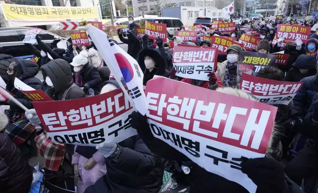 Supporters for impeached South Korean President Yoon Suk Yeol stage a rally against his impeachment near the Seoul Central District Court in Seoul, South Korea, Tuesday, Dec. 17, 2024. The signs read "Oppose the impeachment and Arrest opposition Democratic Party leader Lee Jae-myung." (AP Photo/Ahn Young-joon)