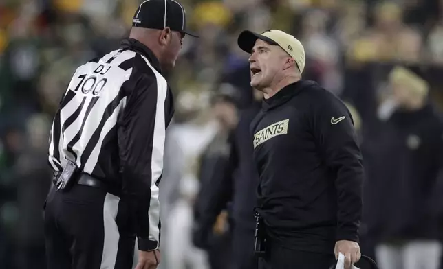 New Orleans Saints interim head coach Darren Rizzi challenges umpire Fred Bryan (11)during the first half of an NFL football game against the Green Bay Packers, Monday, Dec. 23, 2024, in Green Bay, Wis. (AP Photo/Matt Ludtke)