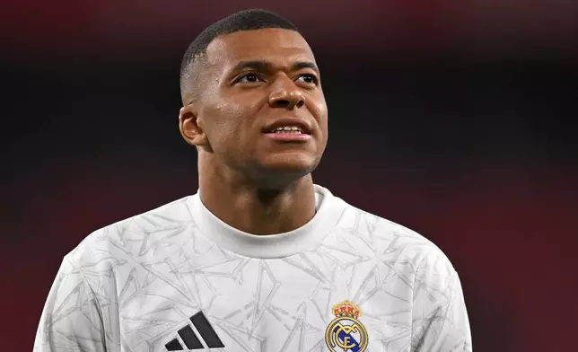 Real Madrid's Kylian Mbappe warms up prior the Spanish La Liga soccer match between Athletic Bilbao and Real Madrid at the San Mames stadium in Bilbao, Spain, Wednesday, Dec. 4, 2024. (AP Photo/Miguel Oses)