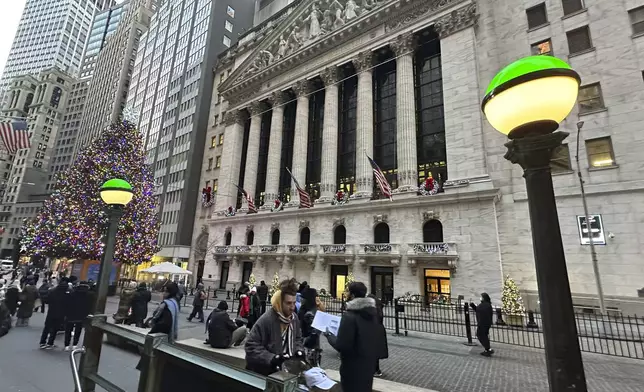 Lights marking the entrance to a subway station frame the New York Stock Exchange in New York's Financial District on Monday, Dec. 23, 2024. (AP Photo/Peter Morgan)