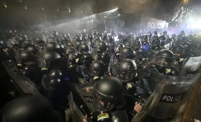 Police use a water cannon on protesters during a rally outside the parliament to protest the government's decision to suspend negotiations on joining the European Union for four years in Tbilisi, Georgia, early Saturday, Nov. 30, 2024. (AP Photo/Zurab Tsertsvadze)