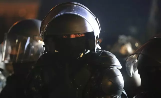 A police officer looks on during a rally outside the parliament's building to protest the government's decision to suspend negotiations on joining the European Union for four years in Tbilisi, Georgia, on Saturday, Nov. 30, 2024. (AP Photo/Zurab Tsertsvadze)